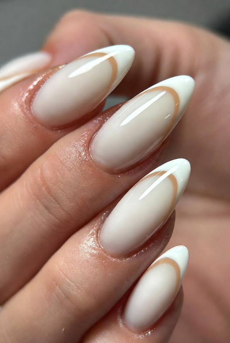 Almond nails in sheer nude, with a thin milk white smile curve across the tip. The curve is narrow and centered, glossy finish.