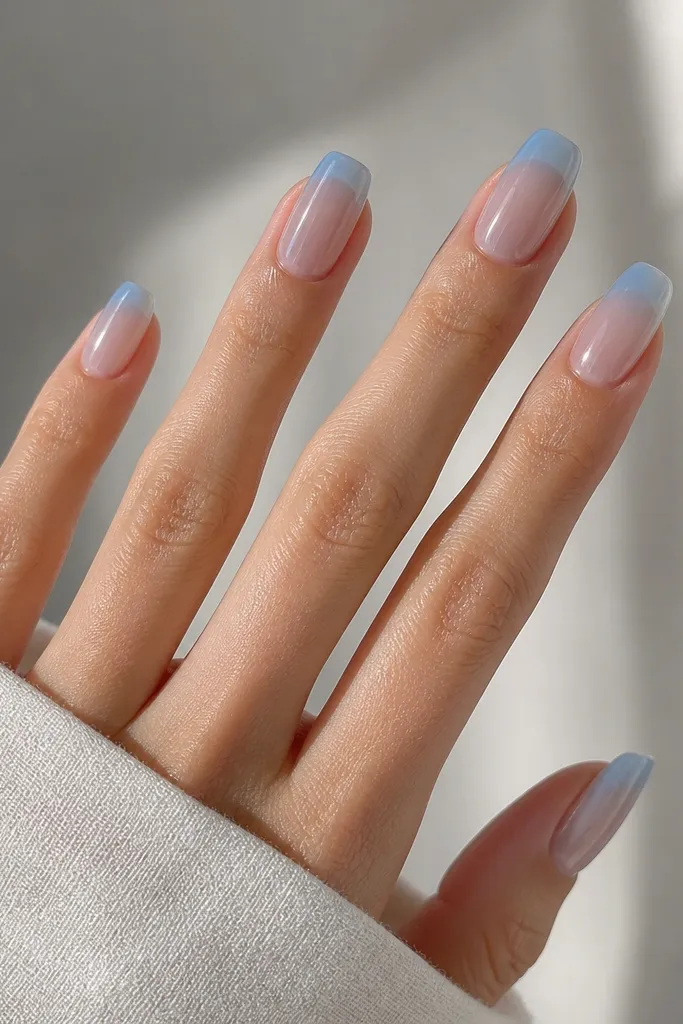 Translucent clear jelly nails tinted baby sky blue. The nails look see-through with a glossy, glassy layer and natural nail line still visible beneath.