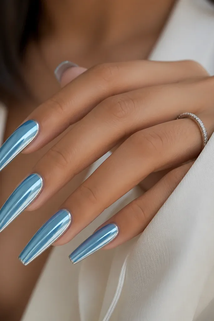 Long coffin nails: sky blue cat eye stripe centered; the outer edges have a thin silver chrome border line running from cuticle to tip.