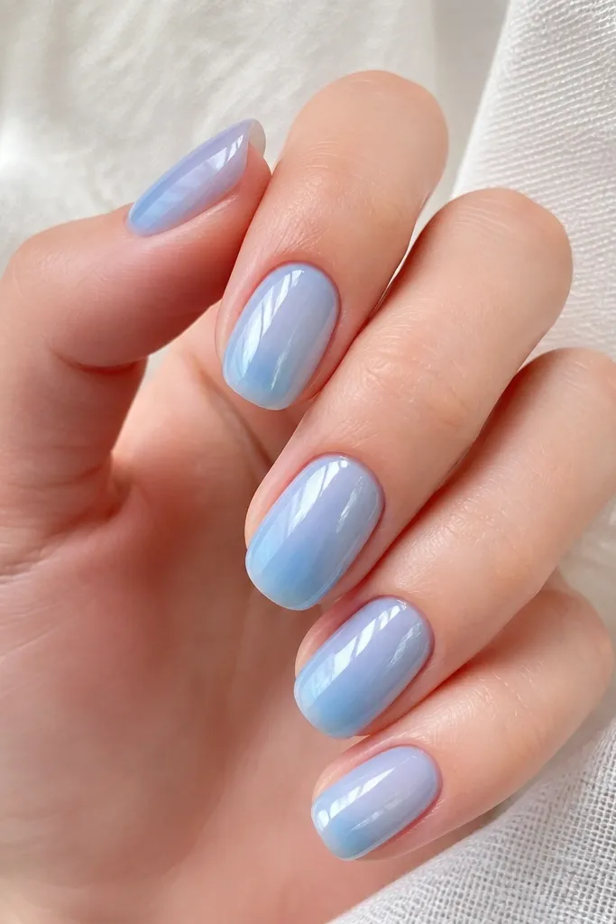 Nails look like sky blue is trapped under glass. The color is slightly translucent, and the shine is high like jelly, with clean cuticles.