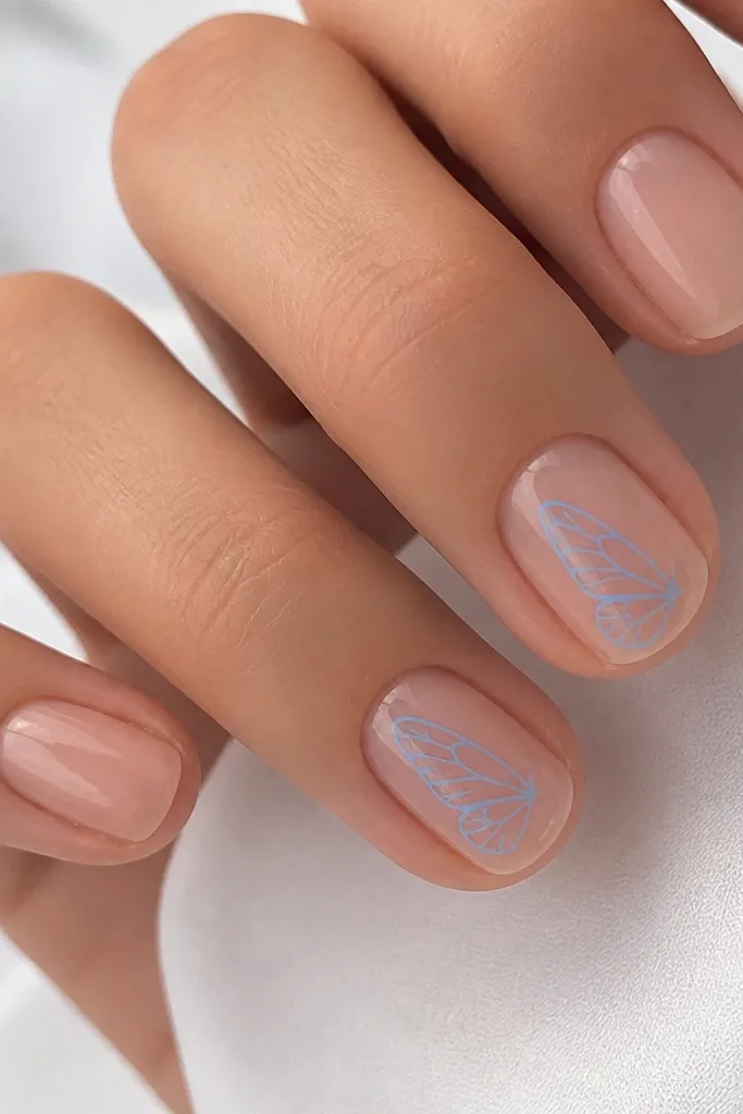 Short nails in sheer nude with a sky-blue butterfly wing outline on one or two nails. The outline is thin and airy, with glossy finish.