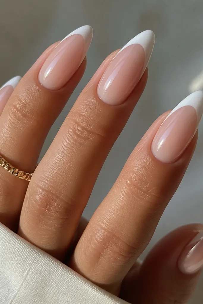 Almond nails with opaque white tips and a see-through jelly-like center; the base looks glossy and dimensional.