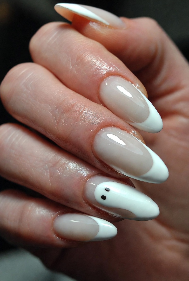 Four nails are sheer nude with standard bright white French tips. One ring finger nail has a sheer nude base with a faint, semi-transparent white French tip that looks like a soft blur. All nails are glossy.