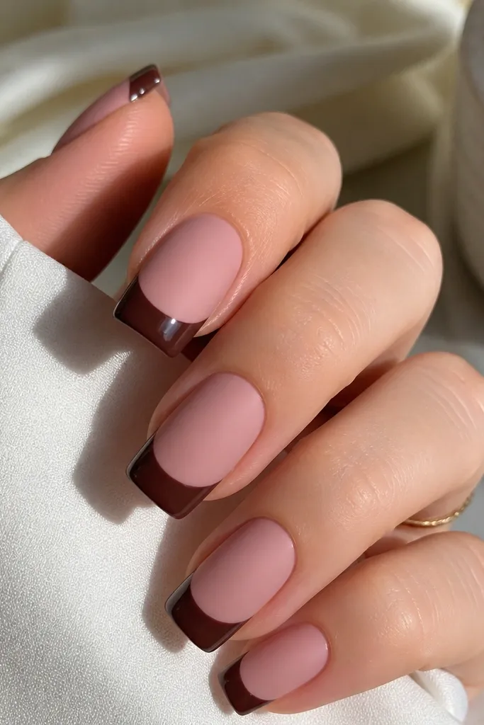 Square nails where the base is a soft matte nude pink. The French tip is a deep chocolate brown with a high-gloss shine. The contrast creates a crisp two-tone look.